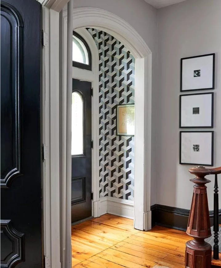 Bold geometric entryway wallpaper ideas featuring modern black and white patterned accent wall in a contemporary hallway.