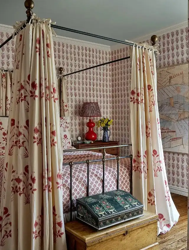 Vintage feminine bedroom ideas showcasing patterned canopy bedding and brass bed frame