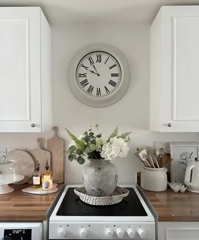 large modern wall clock on blank kitchen wall above counter minimalist kitchen decor design