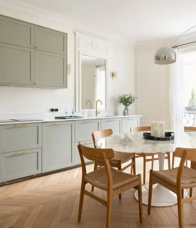 mirror on blank kitchen wall reflecting light making small kitchen look bigger and brighter