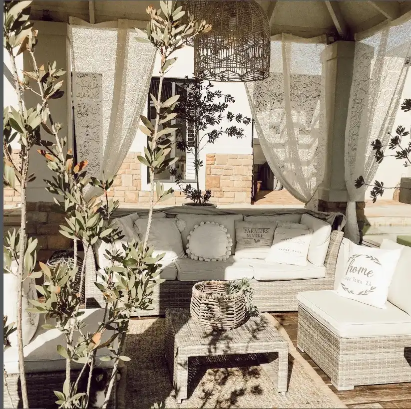 outdoor curtain hanging from wooden pergola