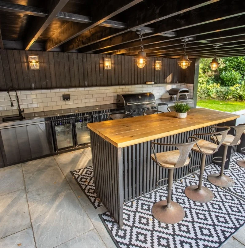 outdoor kitchen wall with warm lighting creating cozy evening cooking space