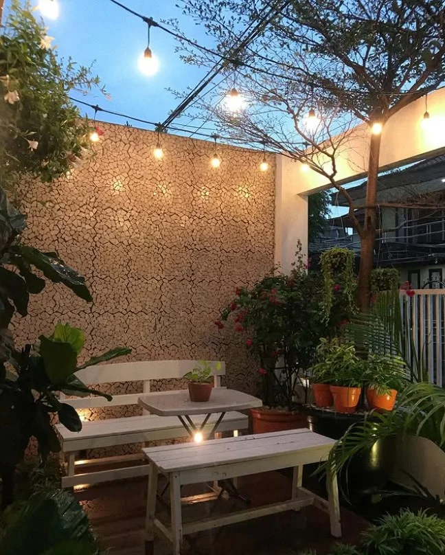 small side porch with warm lighting and cozy setup