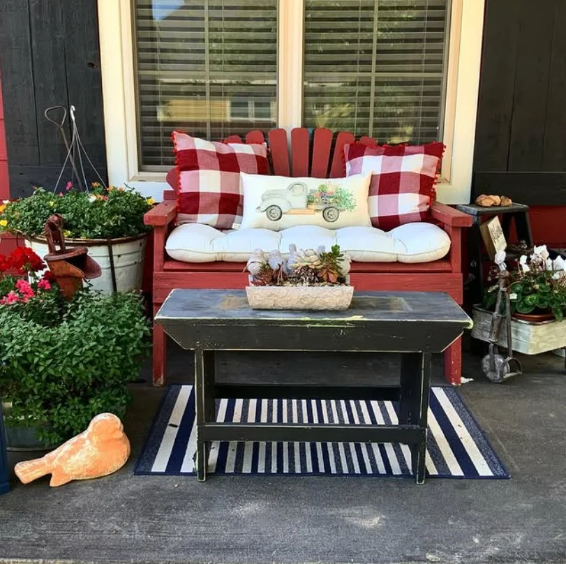 cottage front porch with wooden bench and soft cushions