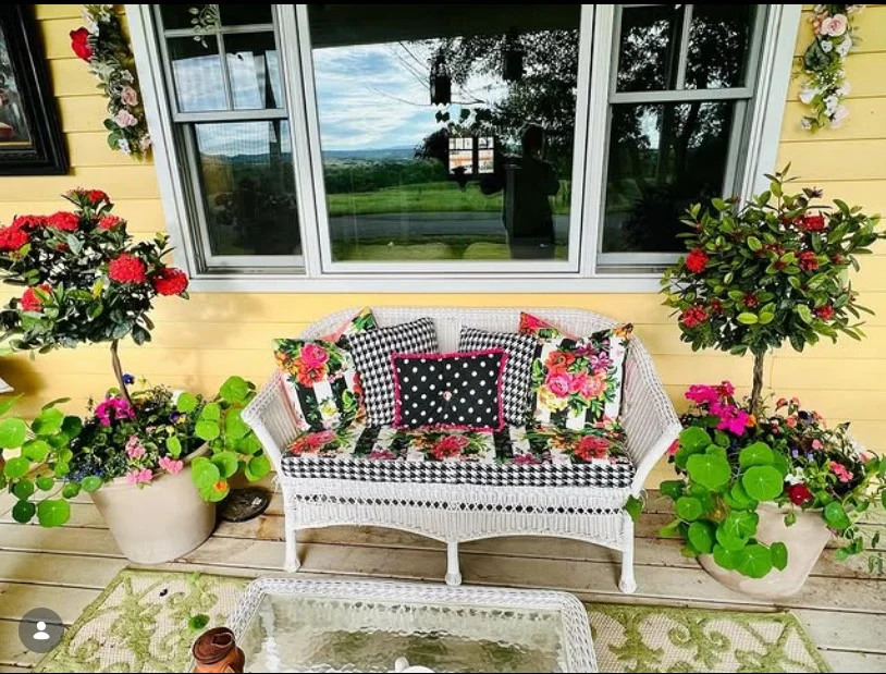 cottage front porch with floral cushions and pillows
