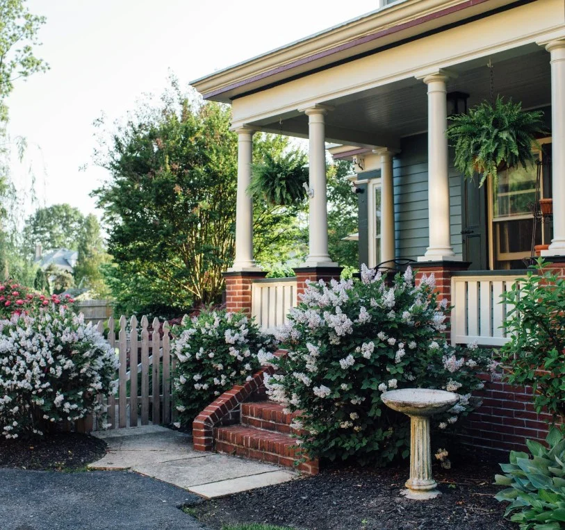small side porch with railing planter box greenery