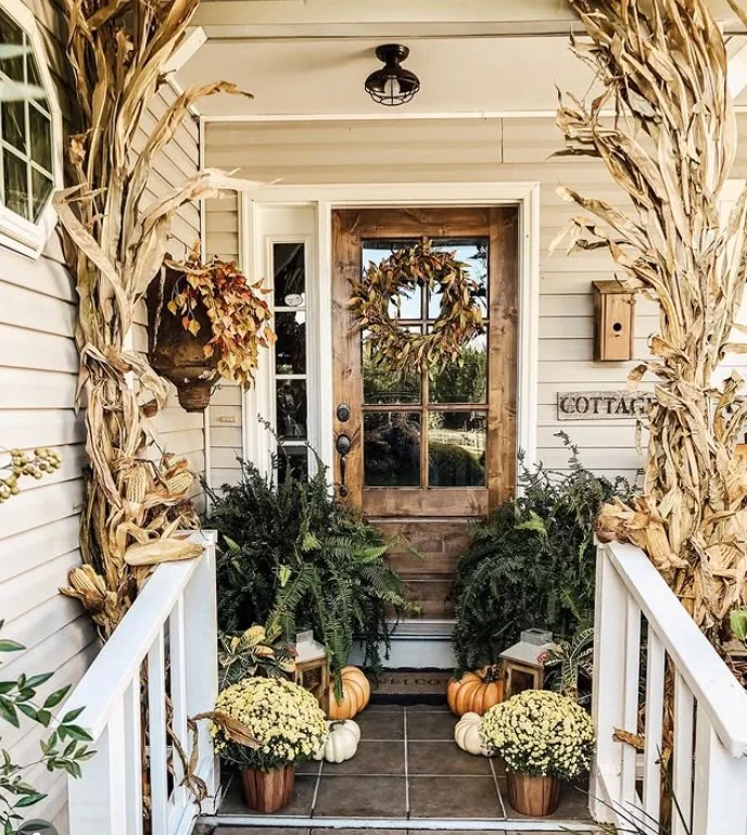 cottage front porch with seasonal decorations and flowers