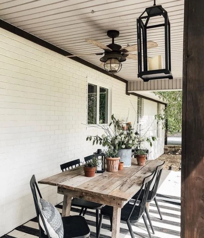 cottage front porch with small table and decor items