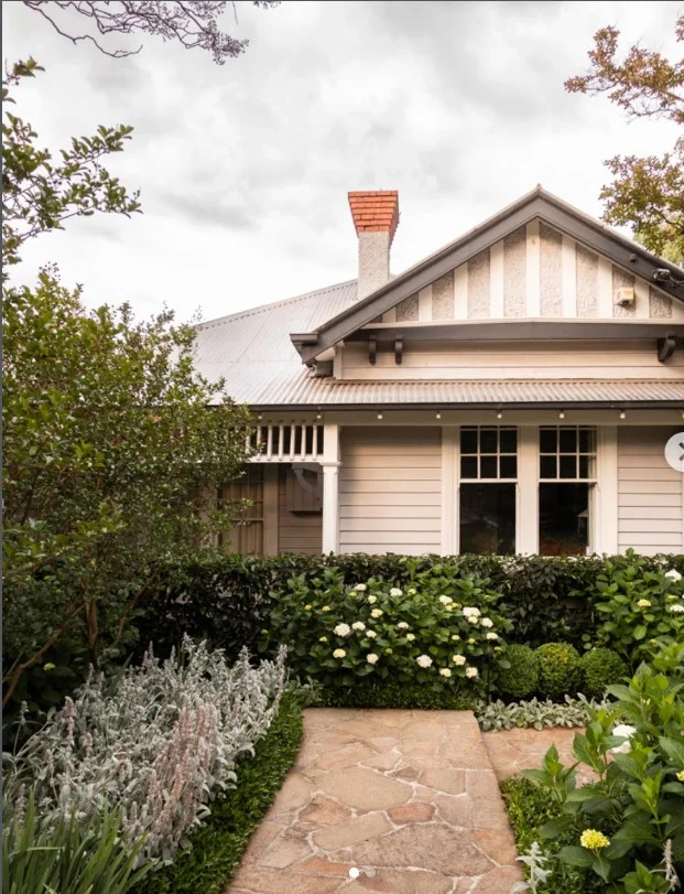 bungalow front porch with stone pathway and landscaped entry