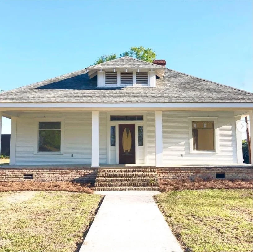 bungalow front porch with symmetrical entry decor and planters
