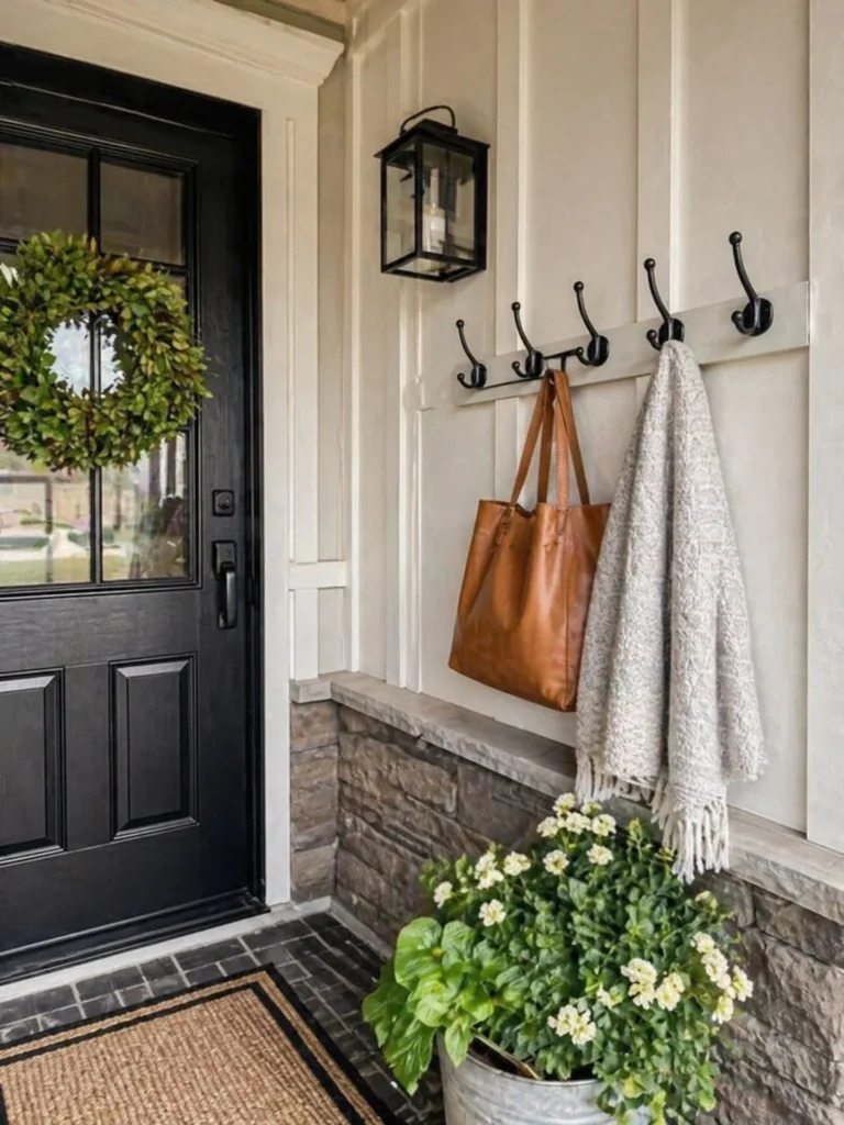 townhouse front porch with wall hooks for storage and decor