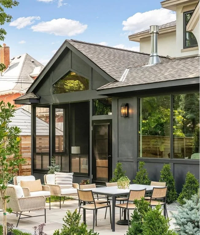 bungalow front porch with warm lantern lighting at night