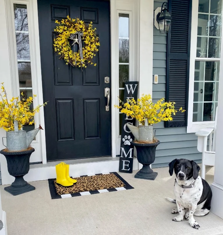 cottage front porch with welcome sign at entry