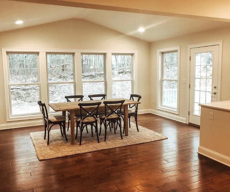 neutral colored 4 season room connected to kitchen area