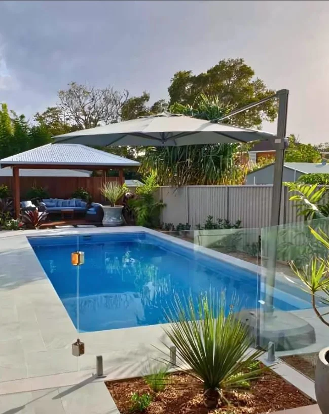 covered pergola over above ground pool deck
