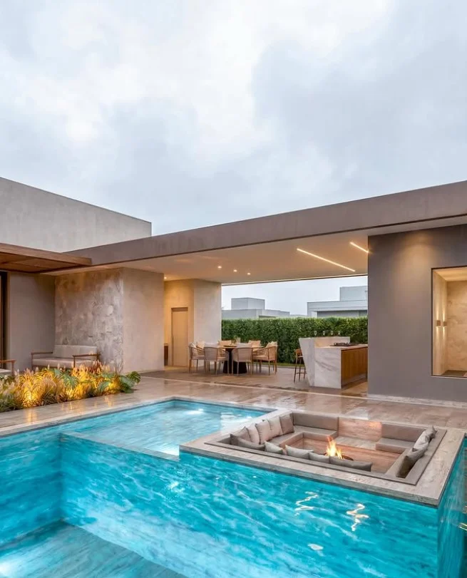 fire pit seating area near modern backyard pool