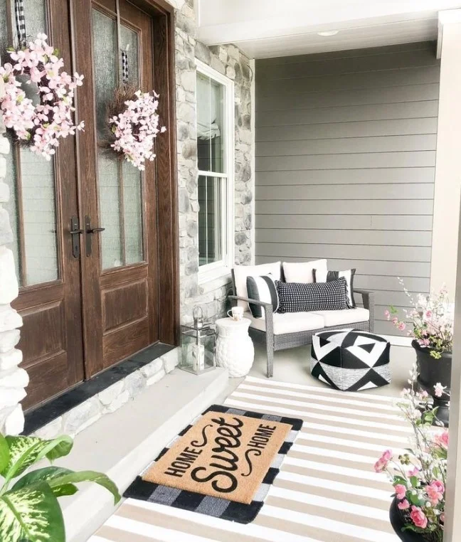 front door porch with comfortable seating and cushions