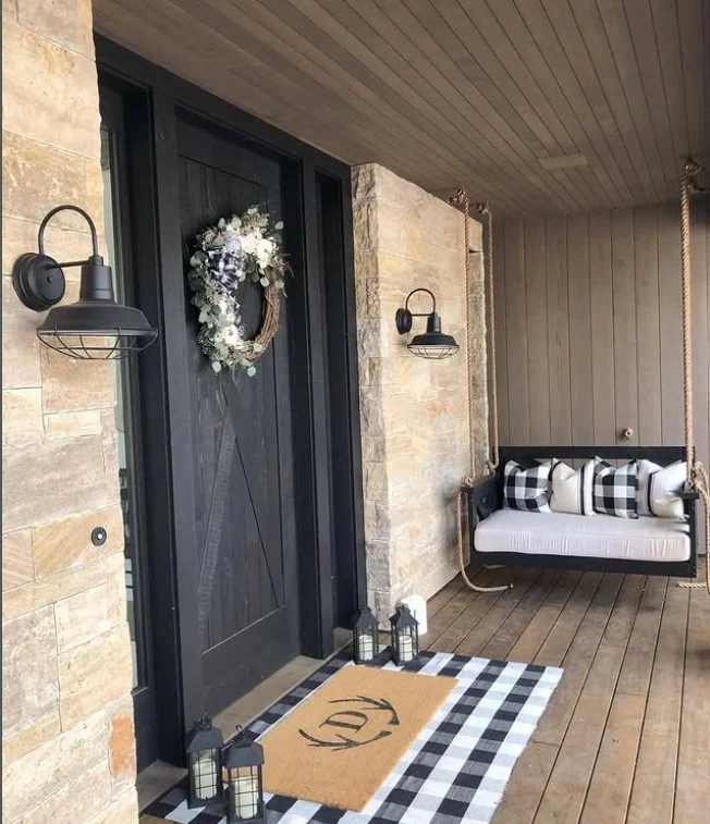 cozy front porch entrance with relaxing porch swing