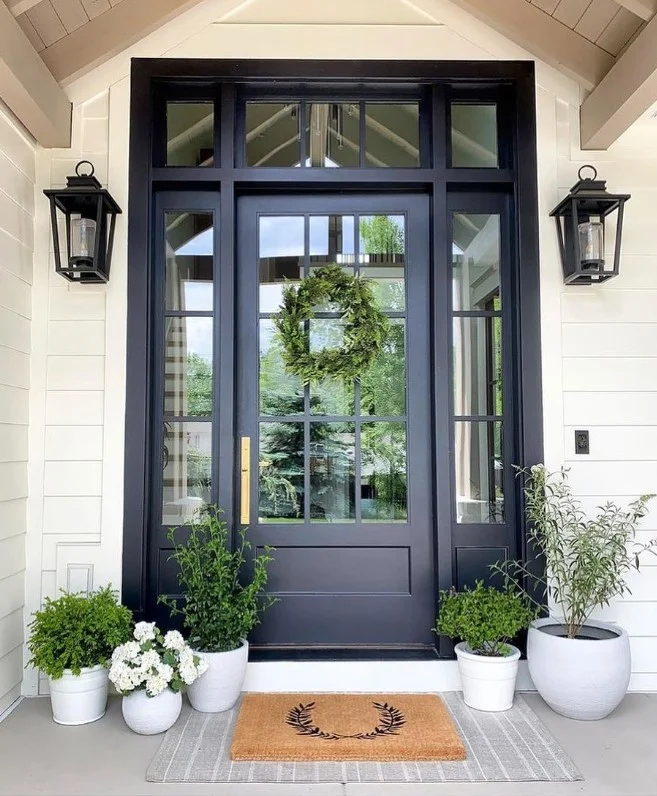 front door porch entrance with matching potted plants decor