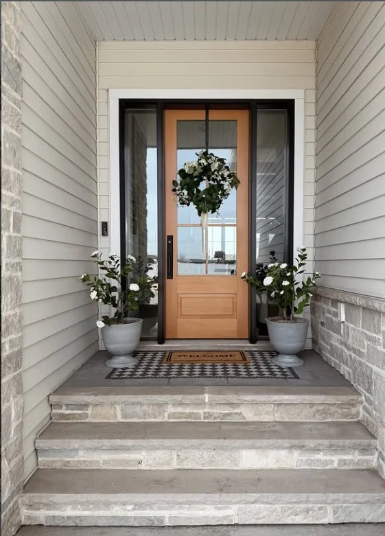 front door with stylish wreath small stoop decor idea