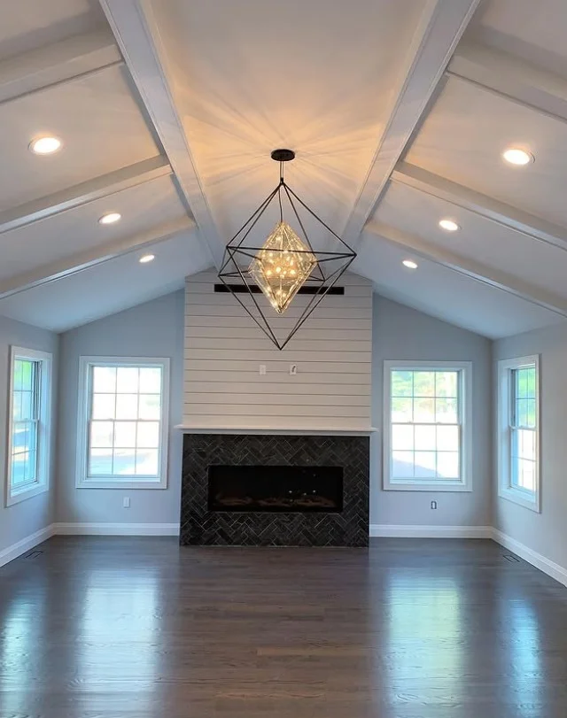 layered lighting in stylish family room off back of house