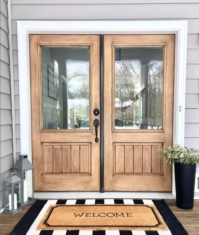 layered welcome mat outside stylish front door entrance