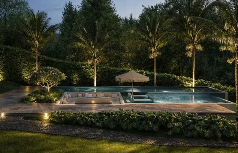 LED lighting around stylish sunken above ground pool at night