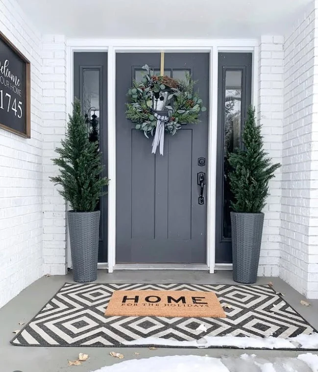 matching planters beside modern front door outside entrance