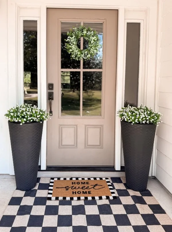 oversized planters beside modern front door entrance
