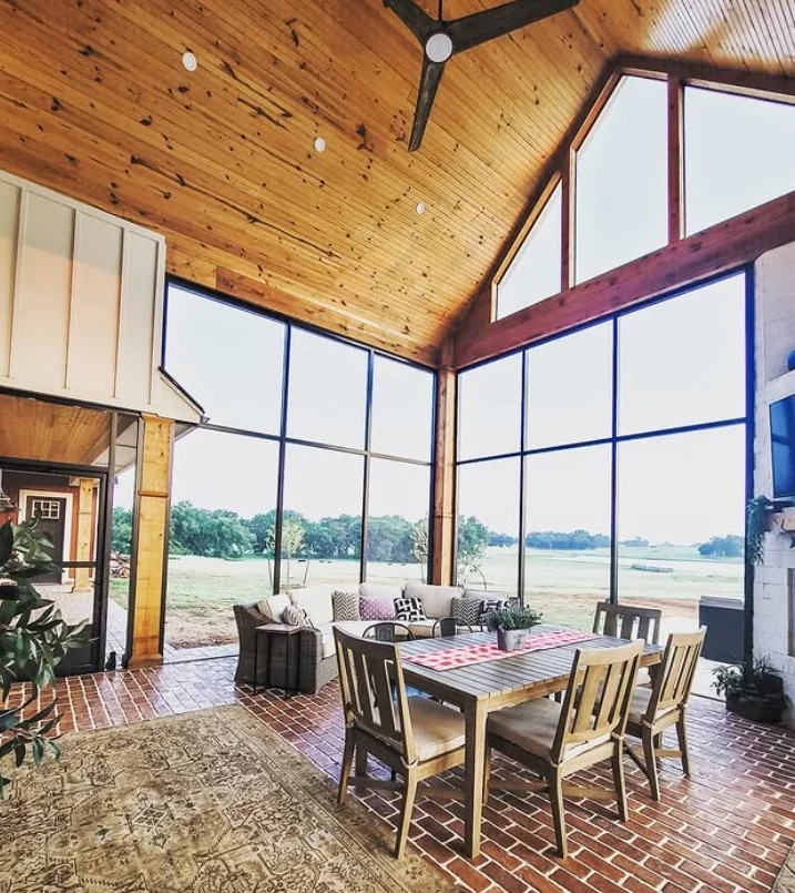 screened porch with natural wood furniture warm rustic style