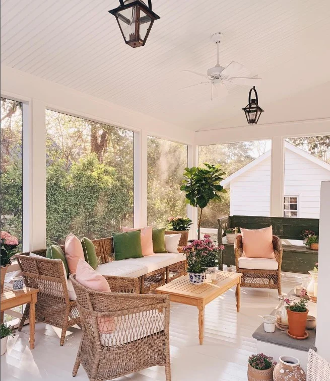 cozy screened in porch with neutral color furniture setup