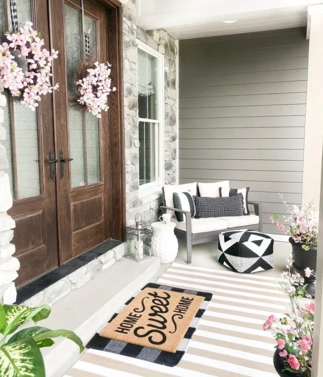 small wooden bench near front door outside entrance