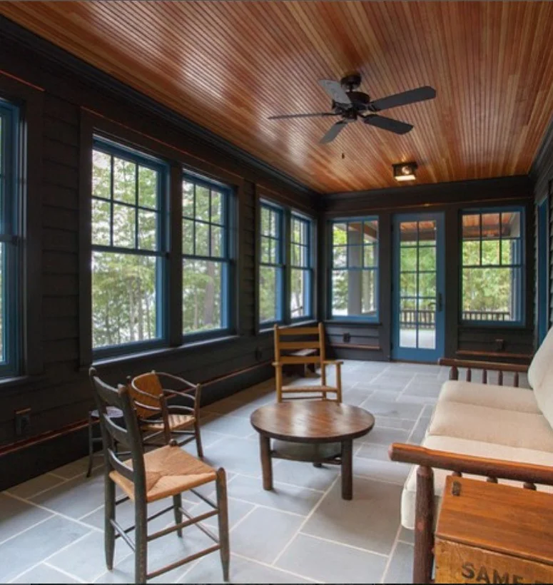 screened patio with small coffee table stylish seating area