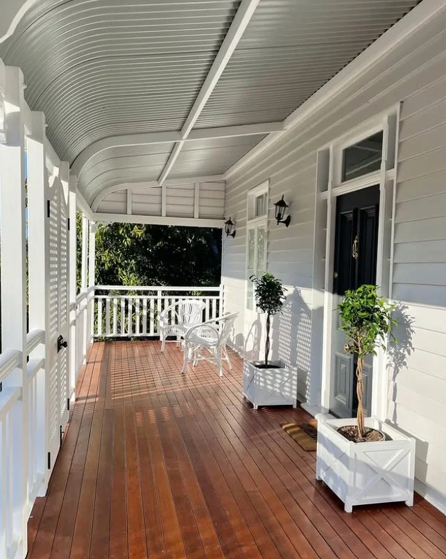 matching planters decorating small front deck entrance