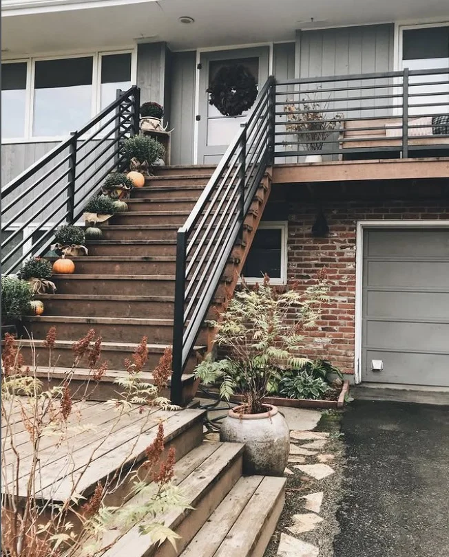 seasonal greenery decorating small front deck entrance