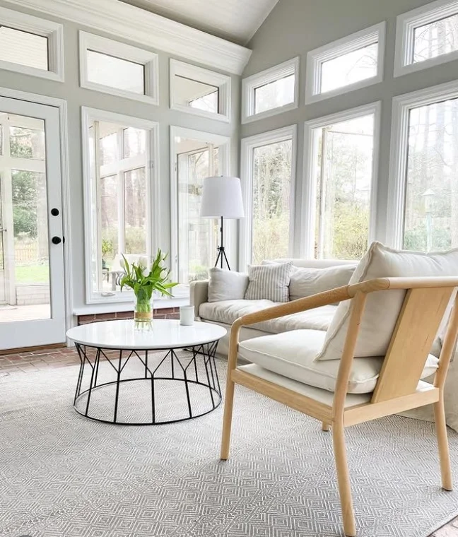 small sunroom with light colored furniture bright cozy design