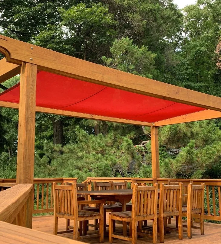 wood deck railing surrounding outdoor dining space
