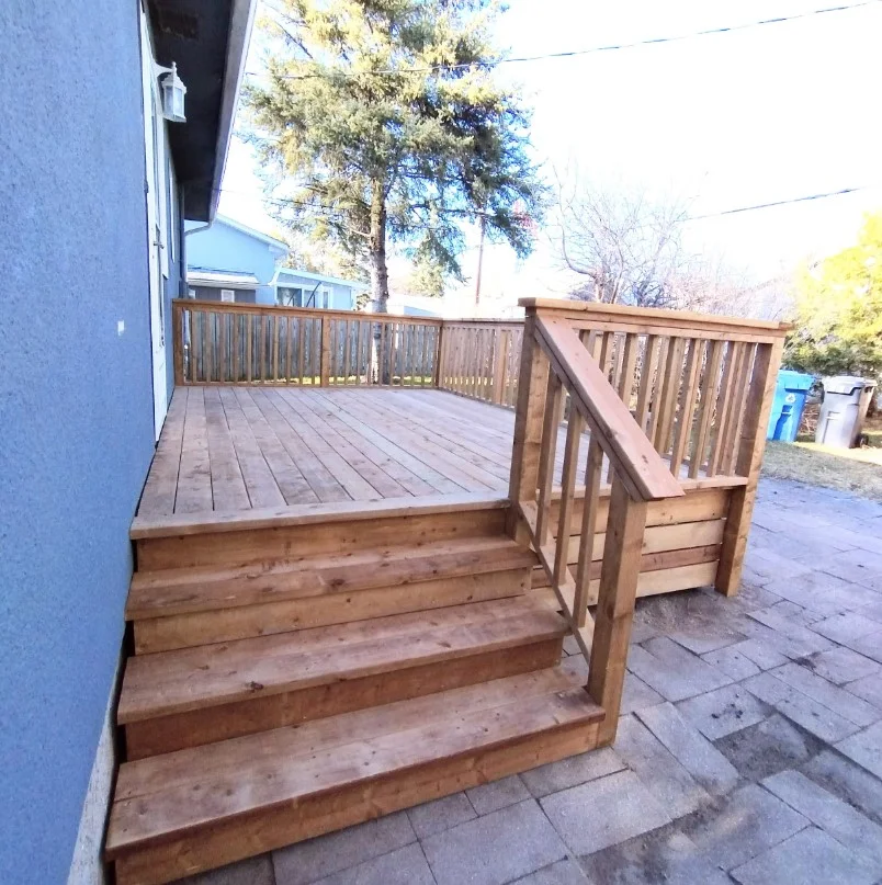 small backyard deck with simple wood railing design