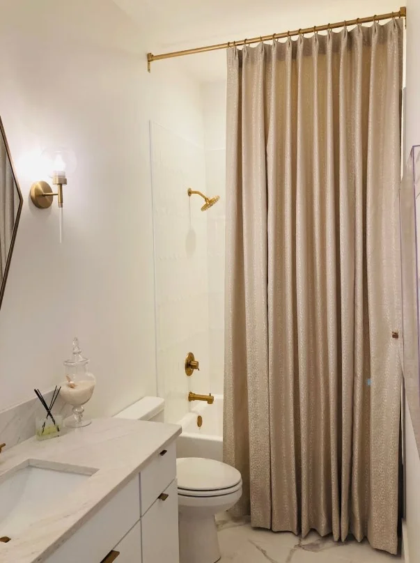 beige shower curtain creating warm bathroom atmosphere