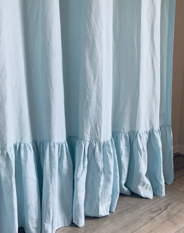coastal blue shower curtain in beach inspired bathroom