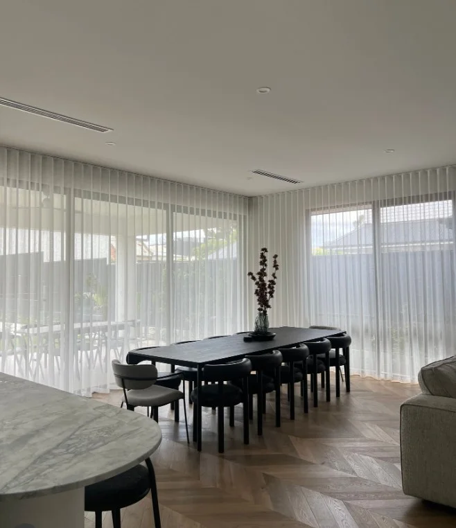 white sheer dining room curtains with bright natural sunlight