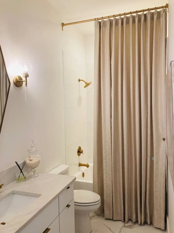 floor to ceiling shower curtain creating taller bathroom look