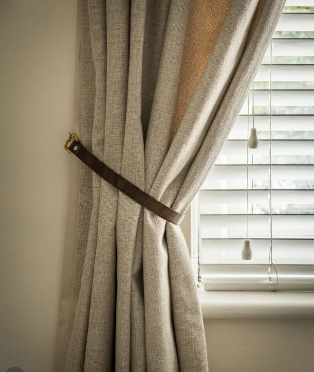 brown leather curtain tie backs with beige curtains
