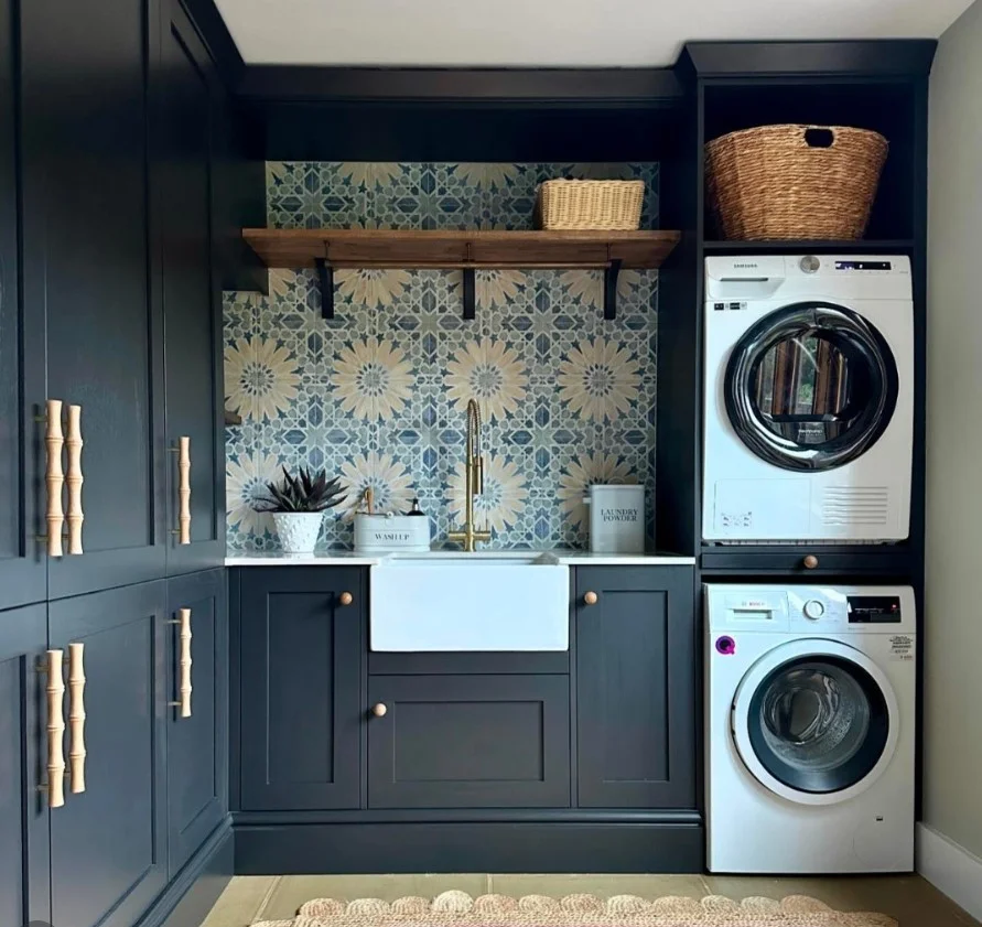 navy blue laundry room cabinets with brass hardware