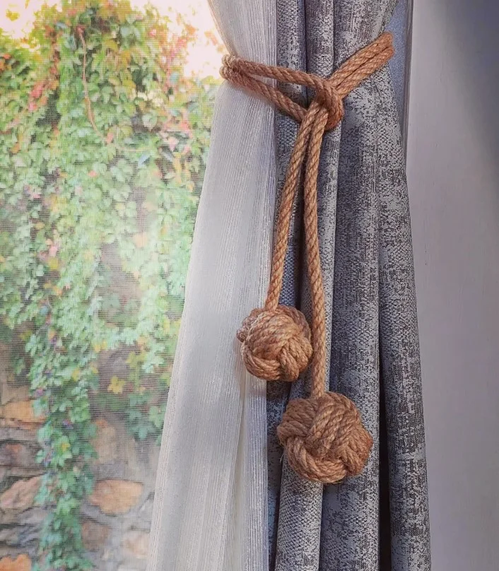 natural rope curtain tie backs in coastal style living room