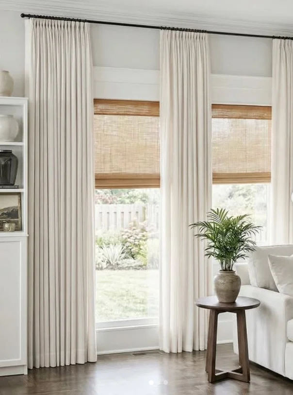cream curtains with black curtain rods in stylish sitting room