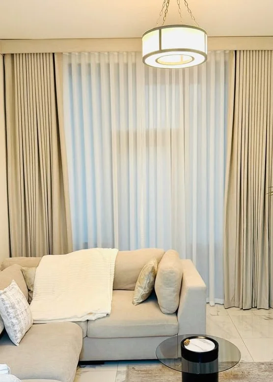 layered sheer and blackout curtains in elegant sitting room