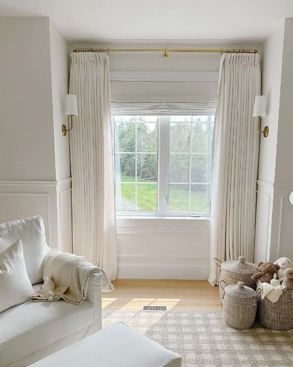 long neutral sitting room curtains creating taller ceiling effect