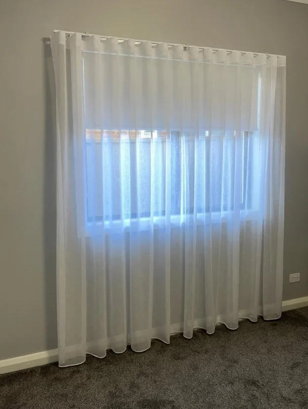 white sheer curtains covering sliding glass doors with natural light