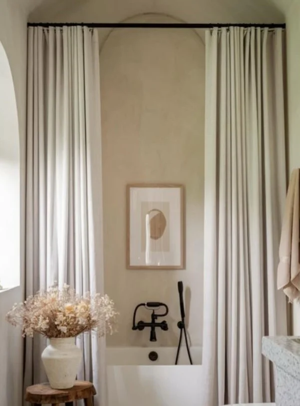white high shower curtain brightening a small bathroom
